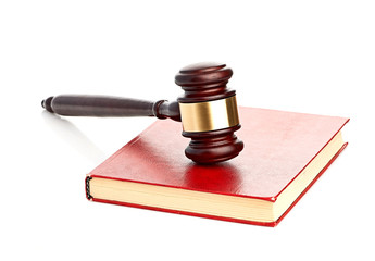 Judge's gavel on red legal book