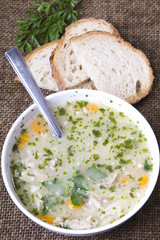 traditional barley soup in a white bowl with bread