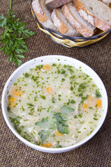 traditional barley soup in a white bowl with bread