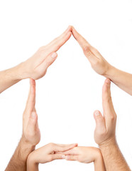 Hands of three people made a home shape