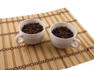 Coffee beans, coffee cup on bamboo background