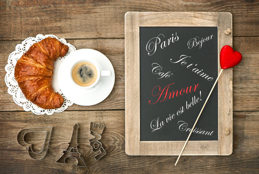 coffee with croissant, blackboard and heart decoration