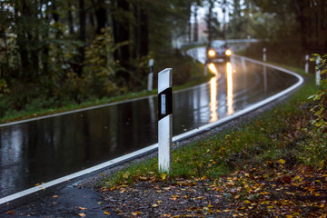 dangerous bad weather car driving on a curvy street