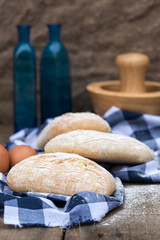 Panini rolls in rustic kitchen setting with cooking utensils