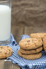 Rustic setting with chocolate chip cookies and glass of milk