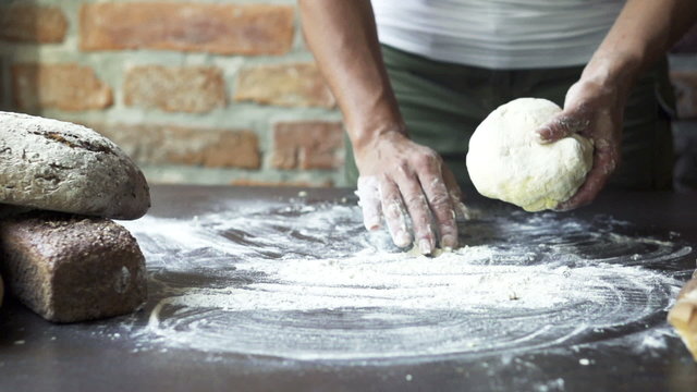 woman throwing dough on the table, slow motion at 240 fps