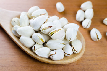 Fototapeta na wymiar pistachio nuts in a wooden spoon