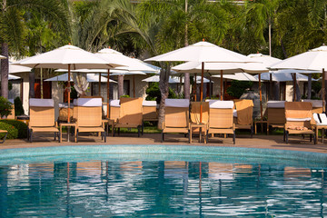 Chaise lounges at pool. Thailand .
