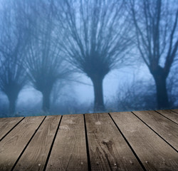 dark atmosphere and empty wooden deck table.