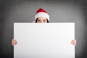 Christmas woman holding white billboard isolated on grey backgro