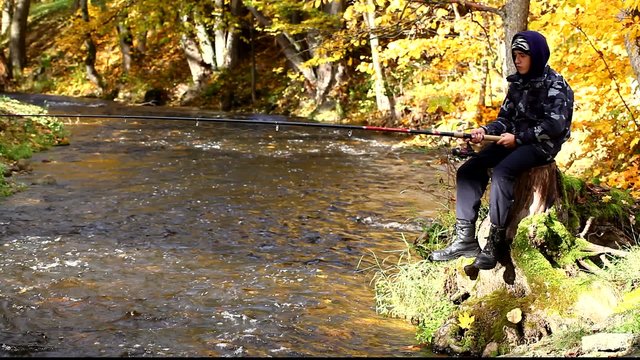 Boy fishing near river in autumn episode 3