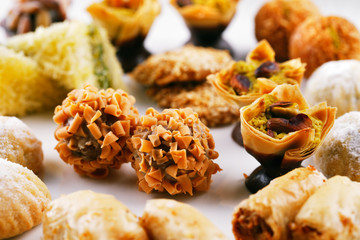 A variety of Arabic sweets on a white background