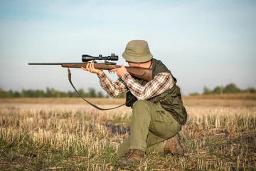 Fototapeten hunter in the hunting shirt and trousers in the hunt © zorandim75