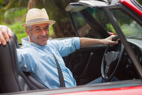 Smiling Handsome Man Posing In Red Convertible