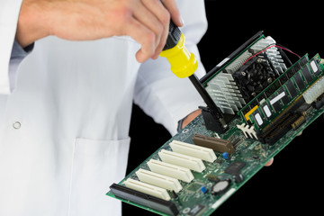Extreme close up of computer engineer repairing hardware at nigh