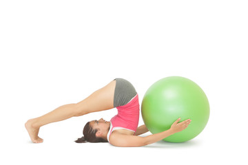 Attractive sporty brunette doing pilates exercise