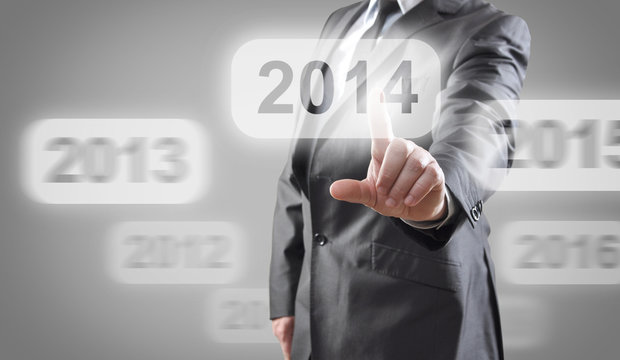 Businessman selects 2014 on touch screen