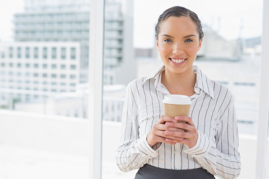 Cute businesswoman holding a coffee
