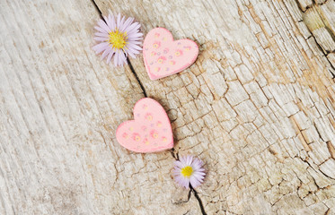 Obraz na płótnie Canvas Two little pink hearts on wooden background