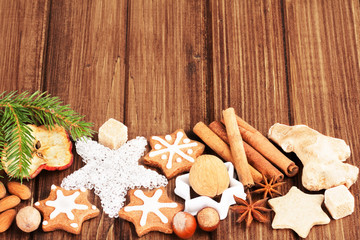 Homemade christmas cookies and spice  on wooden background