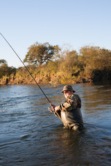 Fisherman catches of salmon at sunset.