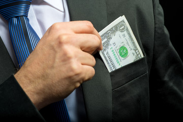 Businessman pulling their money out of pocket