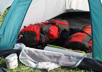 backpacks in the tent and a aluminum lunchbox