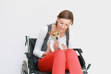junge Frau im Rollstuhl mit Hund