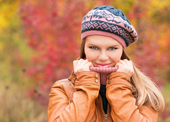 Portrait of beautiful blond woman over autumn forest background