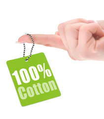 female hand showing hundred percent cotton tag