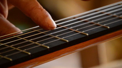 Luthier playing the strings of a guitar