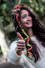 young party woman with confetti and thumb up