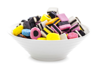 liquorice allsorts in a bowl isolated on a white background