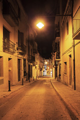Fototapeta na wymiar Deserted streets of old town lit a lantern