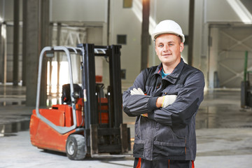 warehouse worker in front of forklift