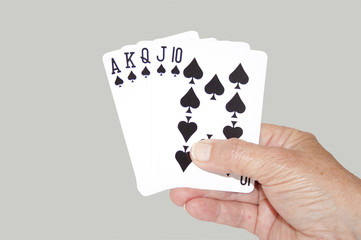 Isolated Hand Held Royal Flush Of Spades