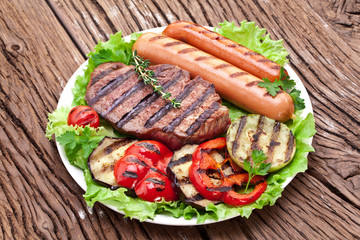 Grilled steak,sausages and vegetables.