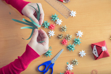 Female hands making Christmas decorations