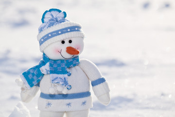 Fototapeta premium Little snowman with carrot nose in the snow.