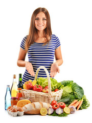 Young woman with assorted grocery products isolated on white