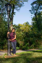 woman holding lamp post