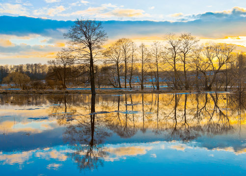 Evening dawn over spring flood of the river
