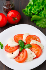 Tomato and mozzarella with basil leaves