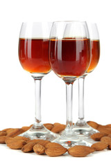 Glasses of amaretto liquor and roasted almonds, isolated