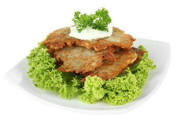 Potato pancakes on plate, isolated on white