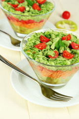 Tasty salad with fresh vegetables on wooden table