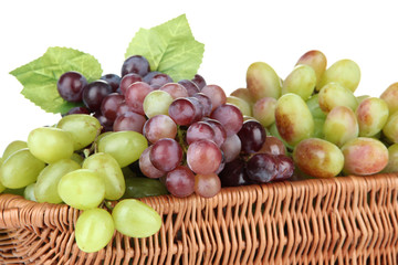 Fresh grape in wicker basket, isolated on white