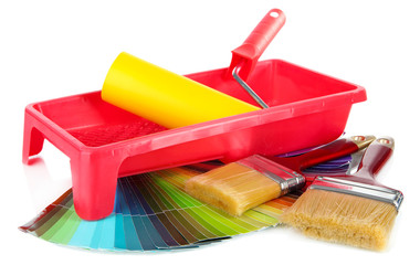 Roller, brushes and bright palette of colors isolated on white