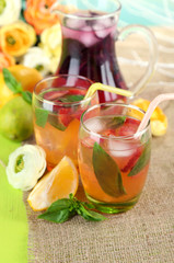 Red basil lemonade in jug and glass,