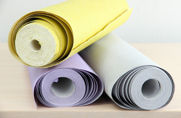 Wallpapers on wooden table in room